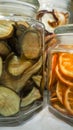 Dried slices of oranges, pears, kiwi in glass jars