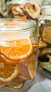 Dried slices of oranges, pears, kiwi in glass jars