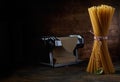 Dried spaghetti and machine with raw dough