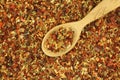 Dried spices and vegetables in a wooden spoon background