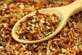 Dried spices and vegetables in a wooden spoon