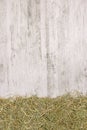 Dried straw grass on a rustic wooden background