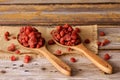 Dried strawberries in a wooden ladles with an old wooden background