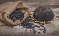 Dried Sunflower and seeds in burlap bag on wooden background Royalty Free Stock Photo