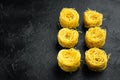 Dried taglierini , on black stone background, with copy space for text Royalty Free Stock Photo