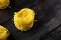 Dried taglierini , on old dark  wooden table , with copy space for text Royalty Free Stock Photo