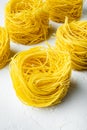 Dried taglierini , on white stone  surface Royalty Free Stock Photo