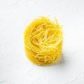 Dried taglierini , on white stone  surface, square format Royalty Free Stock Photo