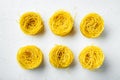 Dried taglierini , on white stone  surface, top view flat lay Royalty Free Stock Photo