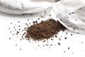 Dried tea leaves spilling out of a broken tea bag. Royalty Free Stock Photo