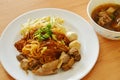 Dried thin rice noodle topping braised pork and brown bone soup