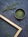 Dried thyme in metal bowl and spread on sieve in wooden frame. Overhead shot