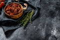 Dried tomatoes with garlic, spices and herbs. Recipe for cooking with ingredients. Black, dark background. Top view. Copy space Royalty Free Stock Photo