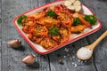 Dried tomatoes with garlic and a spoon with coarse salt on a wooden table. Vegetarian food. Royalty Free Stock Photo