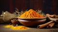 Dried turmeric powder on dark background. Curcuma powder in a wooden bowl with turmeric roots, cinnamon and spices. Popular Indian