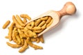 Dried turmeric root in the olive wood scoop, isolated on white, top view