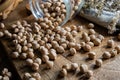 Dried uncooked chickpeas spread on table.