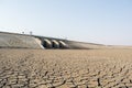 A dried up empty reservoir or dam during a summer heatwave, low rainfall and drought in north karnataka,India Royalty Free Stock Photo