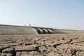 A dried up empty reservoir or dam during a summer heatwave, low rainfall and drought in north karnataka,India Royalty Free Stock Photo