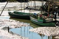 Green fishery boats waiting for high tide in dried-up lake near Gambia-Pontes-Alto da Guerra in Portugal Royalty Free Stock Photo