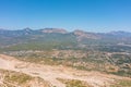 Dried up river bed in a rural countryside with the mountains with a small settlement town on the coast. Majestic landscape with Royalty Free Stock Photo