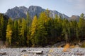 Dried up river bed in a rural countryside with the snowy mountains in the background. Majestic landscape with the rock road and Royalty Free Stock Photo