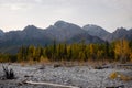 Dried up river bed in a rural countryside with the snowy mountains in the background. Majestic landscape with the rock road and Royalty Free Stock Photo