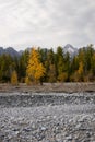 Dried up river bed in a rural countryside with the snowy mountains in the background. Majestic landscape with the rock road and Royalty Free Stock Photo