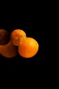 Dried-up spoiled orange on an abstract dark blurry background with a copy space. Ugly fruit. Concept - reduction of organic food Royalty Free Stock Photo