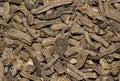 Dried Valerian root pieces (Valeriana officinalis), macro background image.
