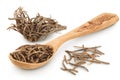 Dried Valerian root in wooden spoon isolated on white background. Valeriana officinalis with full depth of field.