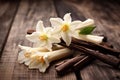 Dried vanilla pods and flowers on wooden background