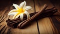 Dried vanilla sticks and vanilla orchid on wooden table. Close-up.