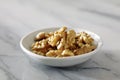 Dried walnuts in white plate on Marble Surface