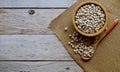 Dried White Kidney Beans in a wooden cup Some are in wooden spoons and sackcloth on the wooden Royalty Free Stock Photo