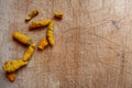 Dried whole turmeric on wooden cutting board background Royalty Free Stock Photo