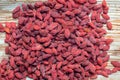 Dried wolfberries on a rustic wooden plate. A bunch of goji berries Royalty Free Stock Photo