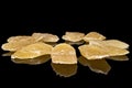 Dried yellow pineapple isolated on black glass