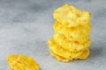 Dried yellow pineapple rings on a grey concrete or stone background. Useful Healthy snack. Selective focus, copy space