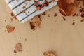 Fallen dried yellow rose petals on the wooden table. Royalty Free Stock Photo