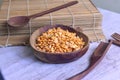 Dried yellow split peas inside wooden bowl on the side of sushi roller Royalty Free Stock Photo