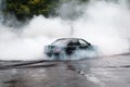 Drift car wheel drifting on the track with smoking tires. scraping the asphalt while racing Royalty Free Stock Photo