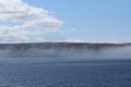 Drifting fog looking across the strait of canso in the afternoon on a sunny spring day Royalty Free Stock Photo