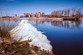The calm flow of the river in early spring when there is still ice and snow. Spring cityscape. Royalty Free Stock Photo