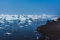 Drifting ice in the sea near the sandy coast. Ice in the sea near the beach Royalty Free Stock Photo