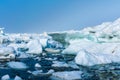 Drifting ice in the sea near the sandy coast. Ice in the sea near the beach