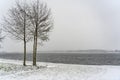 The drifting snow covers the surroundings of lake Zoetermeerse Plas in Zoetermeer