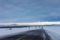 Drifting snow sweeps the road to the mountains in a gloomy sky, Altai, Russia