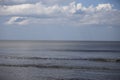 Driftwood Beach ocean view of calm waves, blue skies, and white wispy clouds. Royalty Free Stock Photo