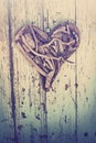 Driftwood heart on vintage wall Royalty Free Stock Photo